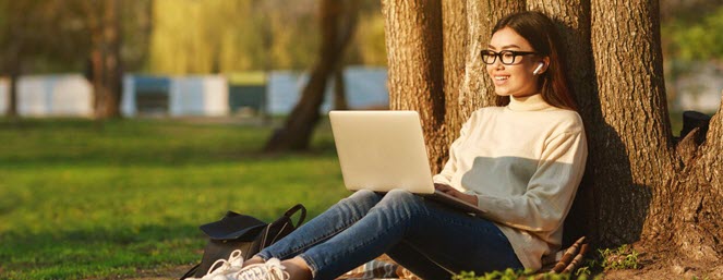 Teen Summer School - teen with laptop working outside