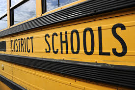 The side of a bus reads District Schools